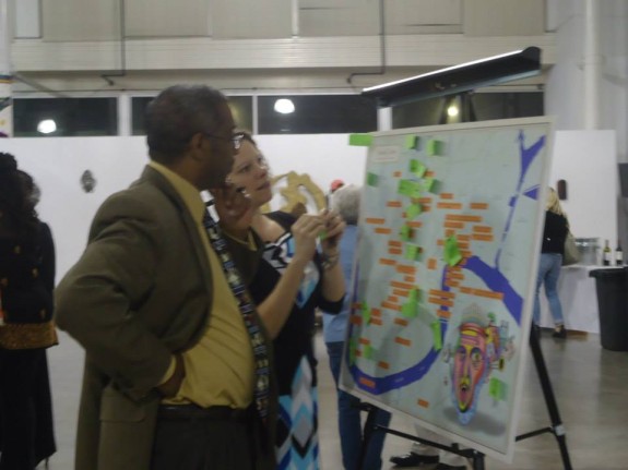 Randall V Schexnayder and Jessica Daigle add "places of relief" to a map during a One Book One New Orleans event about mental health at the Ashe Cultural Arts Center