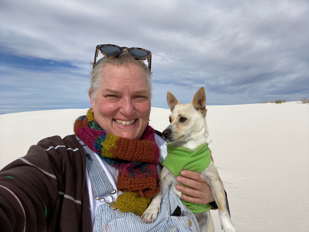 Portrait of Carole Frances Lung with their dog 'Stitch' at White Sands